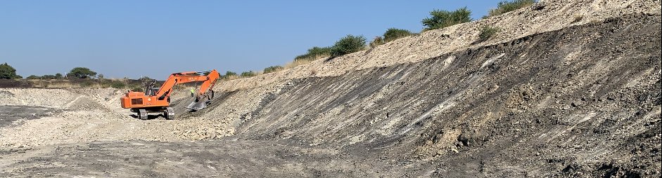 Coal mining operation with excavator working a bench